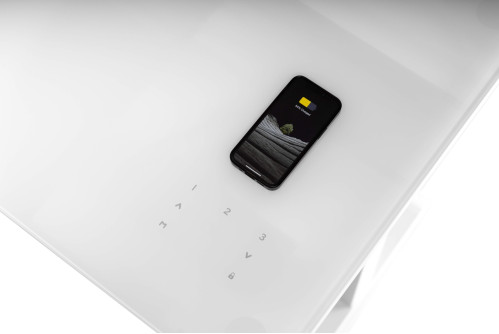 Бюро с безжично зарядно за смартфон, вградено в стъкления плот на Prodesk Elegance